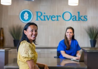 Front desk with patient and nursing conversing about admission at river oaks treatment center
